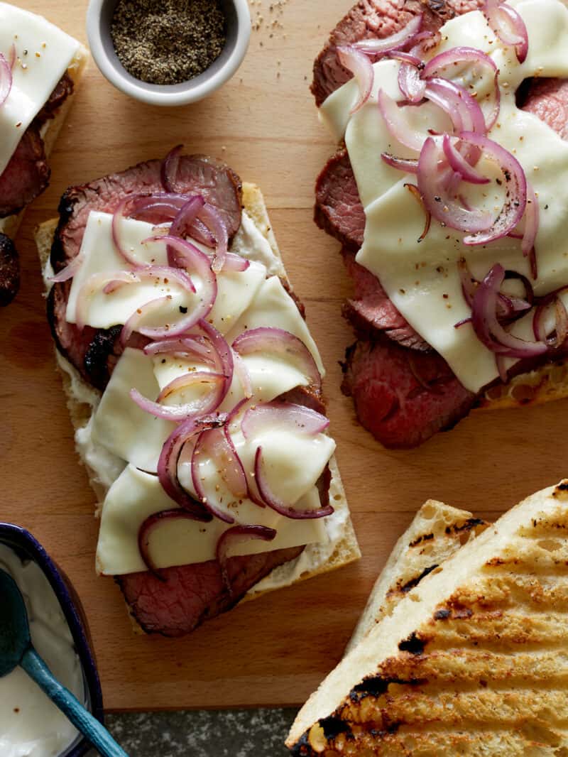 Grilled open face sandwich with tri-tip, cheese, and onion.